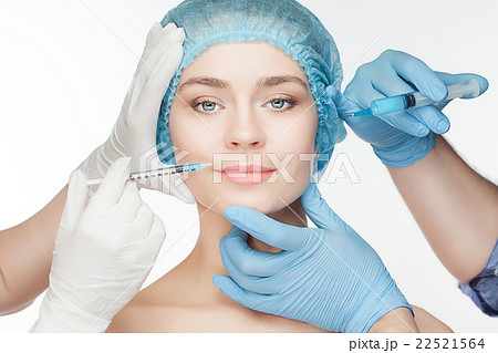 Attractive woman at plastic surgery with syringe Attractive woman at plastic surgery with syringe 22521564