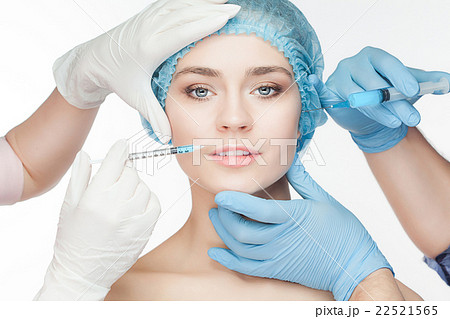 Attractive woman at plastic surgery with syringe Attractive woman at plastic surgery with syringe 22521565