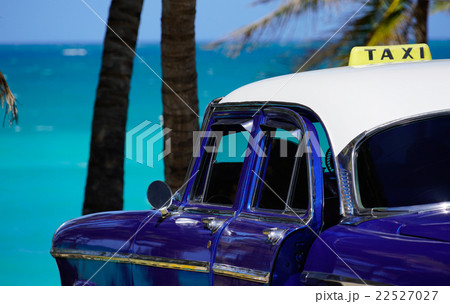 oldtimer taxi car is parking w palms at the sea oldtimer taxi car is parking w palms at the sea 22527027