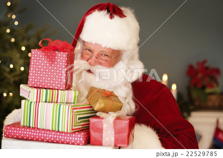 Portrait of Santa Claus holding Christmas presents 22529785