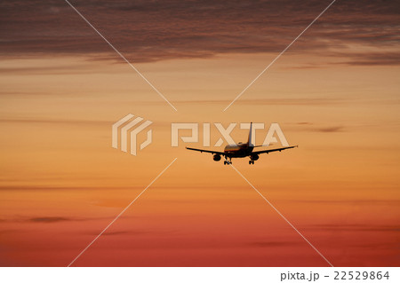 Airplane against orange sky 22529864