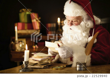 Portrait of Santa Claus reading child's letter at desk 22529940
