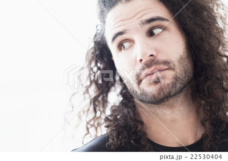 Portrait of young man with long curly hair Portrait of young man with long curly hair 22530404