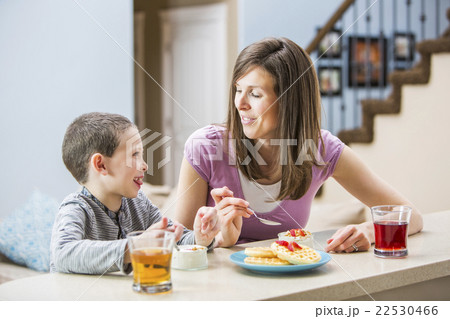 Mother and son (6-7) eating breakfast Mother and son (6-7) eating breakfast 22530466