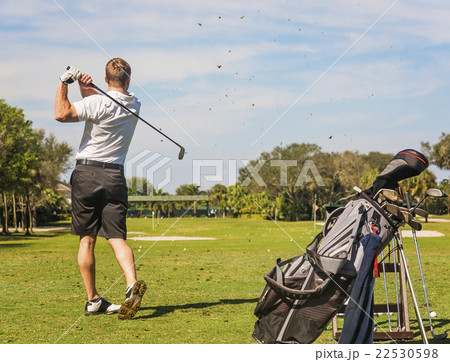 Mid adult man playing golf Mid adult man playing golf 22530598