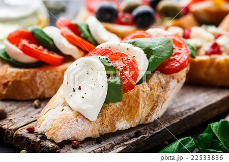 Bruschetta with tomatoes, mozzarella and basil 22533836