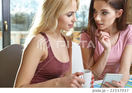 Girls taking pictures on the phone at home Girls taking pictures on the phone at home 22537037