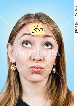 Confused woman with a sticker on her forehead Confused woman with a sticker on her forehead 22538778