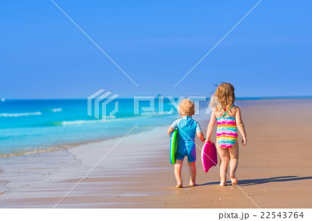 Children with surf boards on tropical beach 22543764
