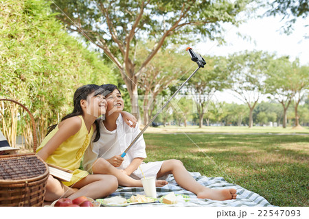 Taking selfie with stick Taking selfie with stick 22547093