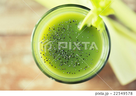 close up of fresh green juice glass and celery close up of fresh green juice glass and celery 22549578