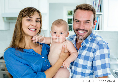 Happy parents with baby boy at home Happy parents with baby boy at home 22550828