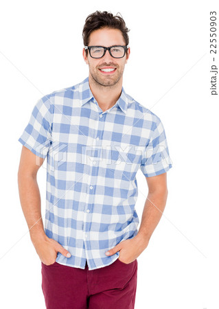 Handsome man is spectacles standing with hands in pockets Handsome man is spectacles standing with hands in pockets 22550903