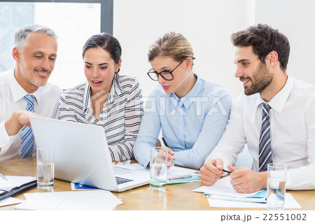 Business colleagues discussing office work on laptop 22551002