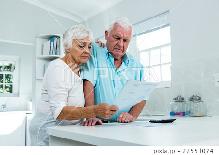 Senior couple calculating finances at home Senior couple calculating finances at home 22551074