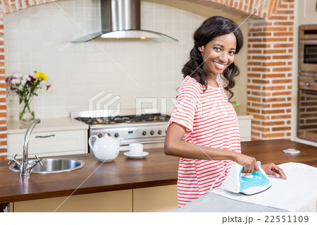 Young woman ironing her clothes 22551109