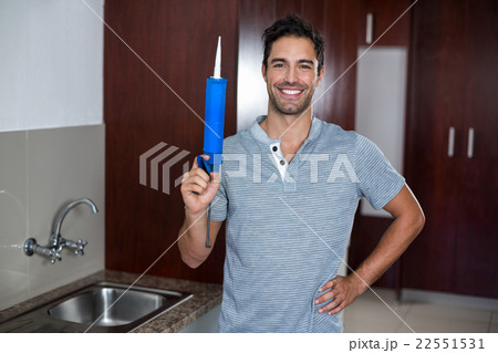 Man with hand on hip while holding pest control injection Man with hand on hip while holding pest control injection 22551531