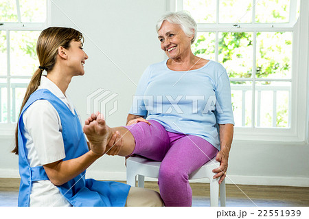 Happy nurse assisting aged woman 22551939
