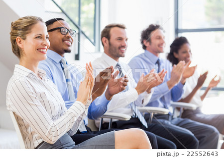 Businesspeople applauding while in a meeting Businesspeople applauding while in a meeting 22552643