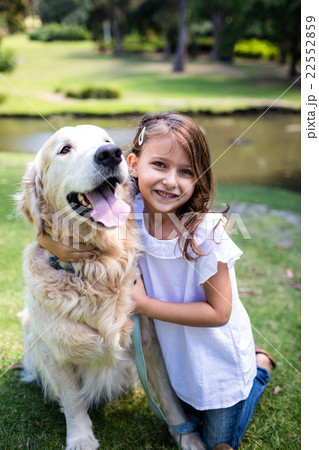 Smiling girl with her pet dog in the park 22552859
