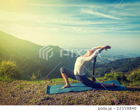 Sporty fit woman practices yoga Anjaneyasana in Sporty fit woman practices yoga Anjaneyasana in 22559840