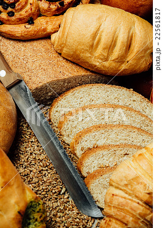 Sliced bread and knife on wooden table Sliced bread and knife on wooden table 22561817