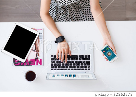 Pleasant woman sitting at the table Pleasant woman sitting at the table 22562575