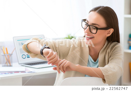 Pleasant woman sitting at the table Pleasant woman sitting at the table 22562747