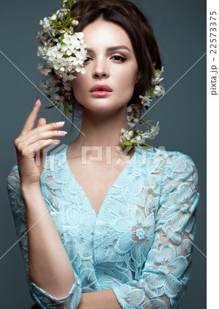 girl in blue dress with flowers. beauty face. girl in blue dress with flowers. beauty face. 22573375