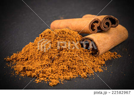 Cinnamon sticks with cinnamon powder on stone 22582967