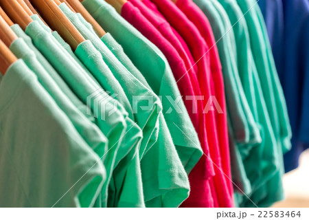 Colorful t-shirts on hangers 22583464