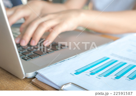 Business woman hand typing on laptop keyboard with Financial charts on the table Business woman hand typing on laptop keyboard with Financial charts on the table 22591587
