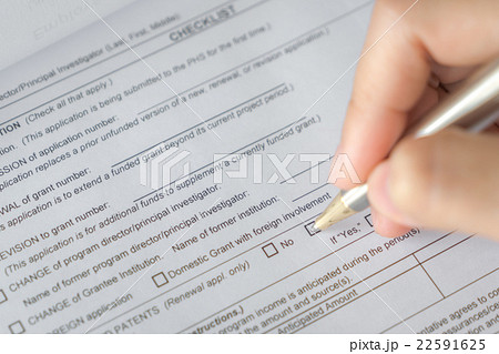 Hand with pen over application form 22591625
