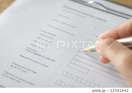 Hand with pen over application form Hand with pen over application form 22591642