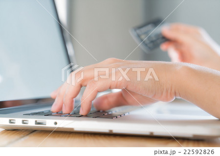 Hands holding a credit card and using laptop computer for online shopping 22592826