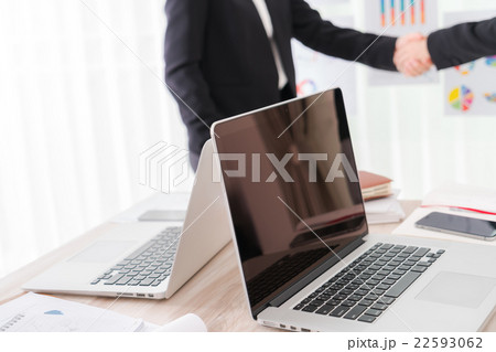 Business people shaking hands over laptop 22593062