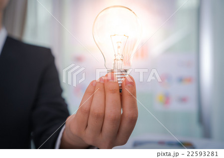 Business man holding light bulb 22593281