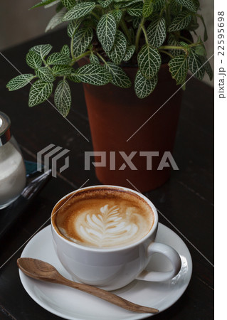 Cup of latte coffee on wooden table 22595698