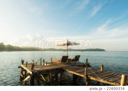 Tropical beach resort with lounge chairs 22600356