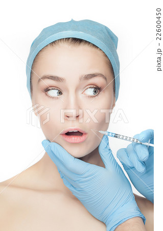 Attractive woman at plastic surgery with syringe 22600450