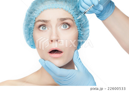 Attractive woman at plastic surgery with syringe 22600533