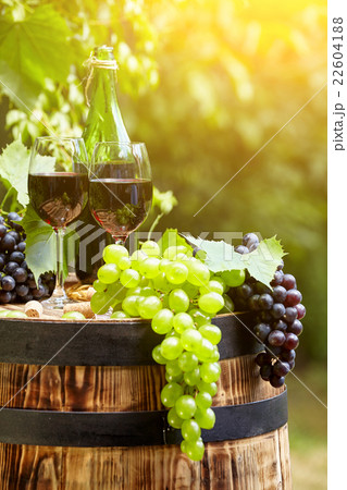 Red wine and glass on wodden barrel. 22604188