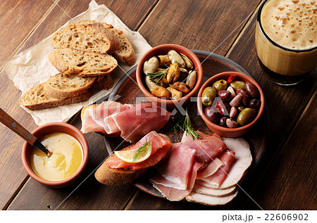 Tapas of salmon mussels jamon and olives with beer Tapas of salmon mussels jamon and olives with beer 22606902
