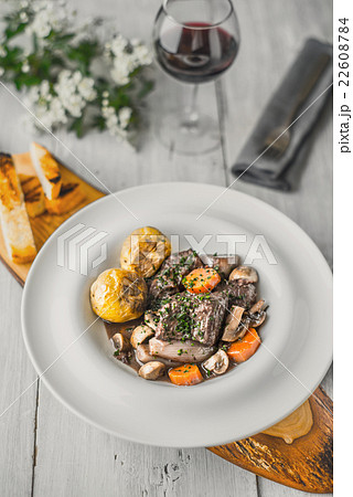 Beef bourguignon in a ceramic dish on a stand 22608784
