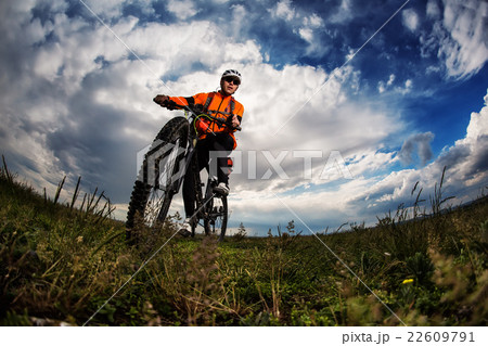 Young man travel by bicycle on rural road Young man travel by bicycle on rural road 22609791