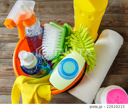 Plastic bucket with cleaning supplies on wood 22610215