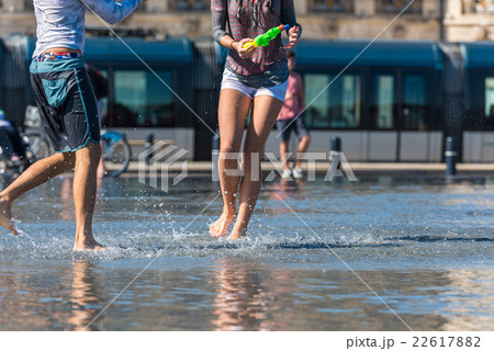People having fun in a mirror fountain in Bordeaux People having fun in a mirror fountain in Bordeaux 22617882