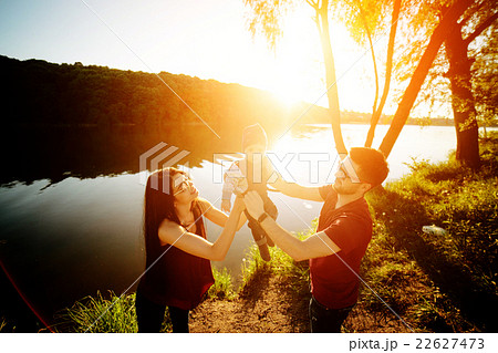 young family with a child on the nature young family with a child on the nature 22627473