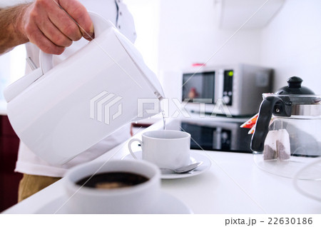Unrecognizable man preparing coffee. Pouring water Unrecognizable man preparing coffee. Pouring water 22630186