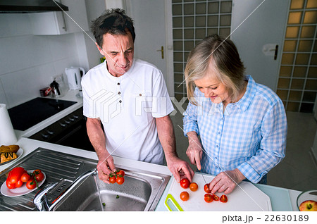 Senior man and woman preparing breakfast. Sunny Senior man and woman preparing breakfast. Sunny 22630189